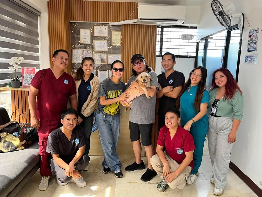 The team with a client and her dog in the front lobby